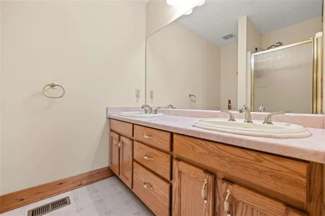 a bathroom with a sink double vanity and a mirror