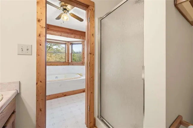 a en suite bathroom with a granite countertop sink and a mirror