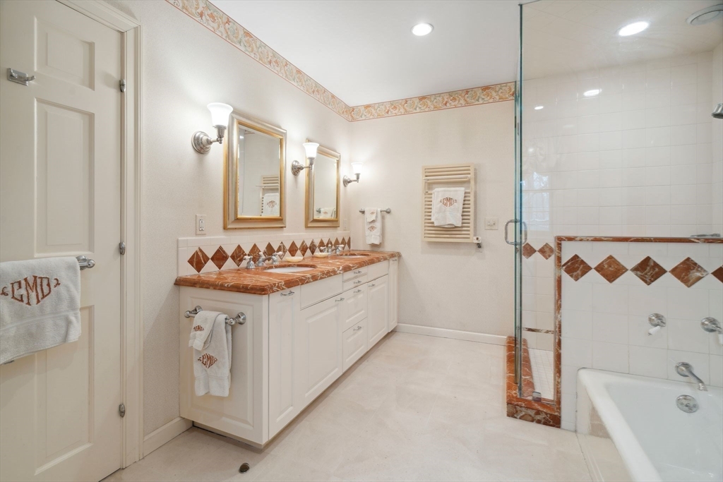 24 Wheeler Road Lincoln, MA 01773 - Photo 22 of 32 a bathroom with a sink double vanity and a shower