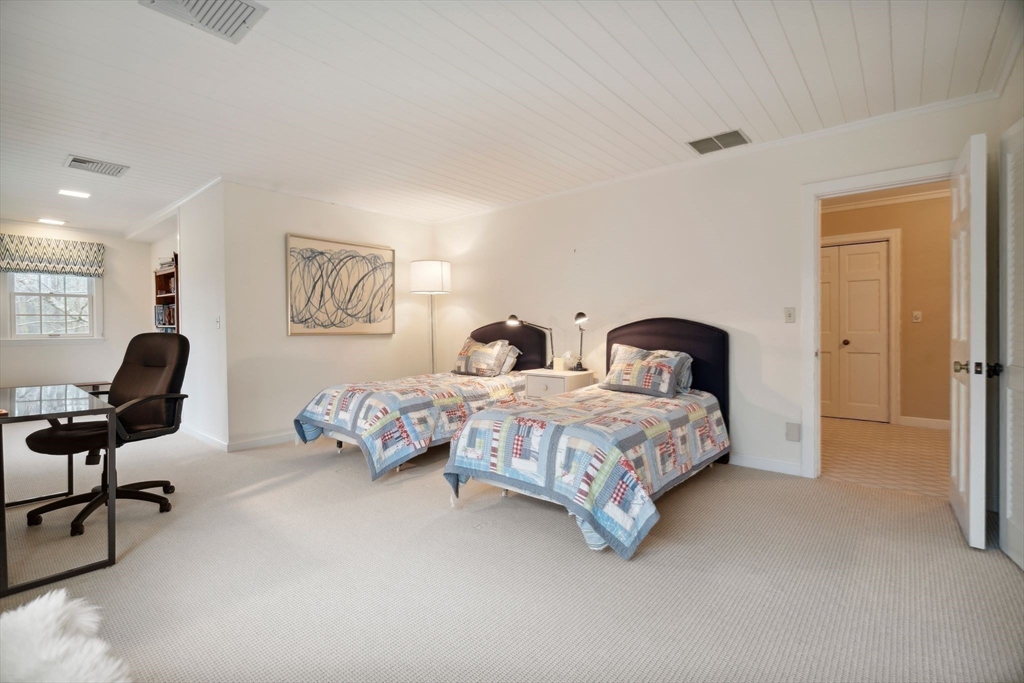 24 Wheeler Road Lincoln, MA 01773 - Photo 23 of 32 a bedroom with a bed and a chandelier