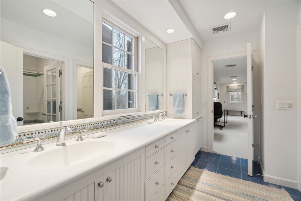 24 Wheeler Road Lincoln, MA 01773 - Photo 24 of 32 a bathroom with a sink double vanity and a mirror