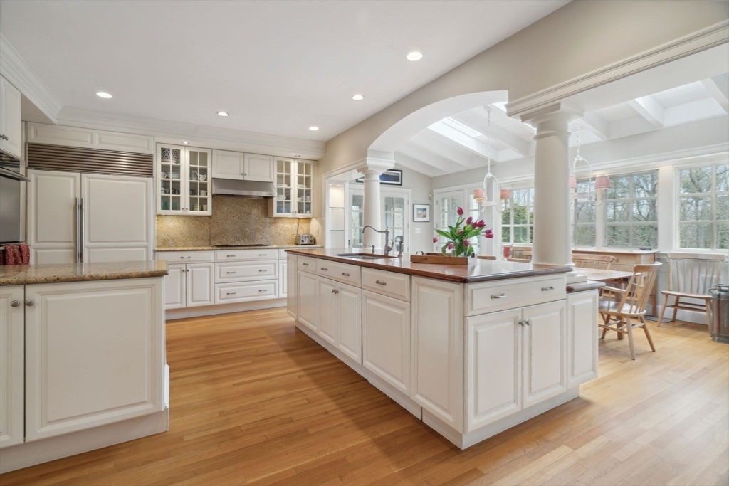 24 Wheeler Road Lincoln, MA 01773 - Photo 5 of 32 an open white kitchen with center island and stainless steel appliances