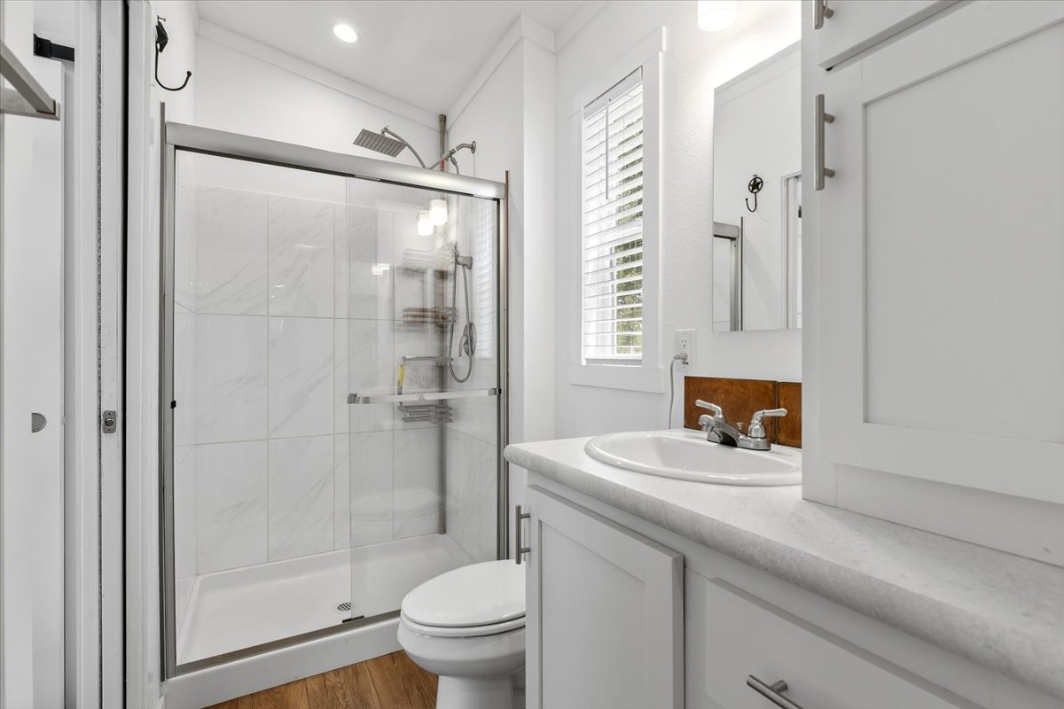 1705 Makinson Road West Point, TX 78963 - Photo 9 of 40 A well-appointed bathroom features a spacious walk-in shower and modern vanity.