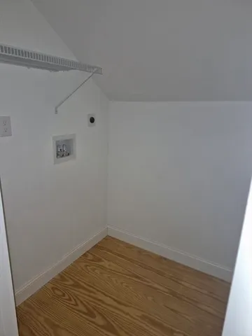 a view of a room with wooden floor