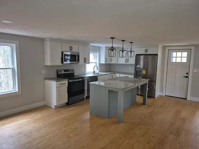 a kitchen with a sink stove and refrigerator