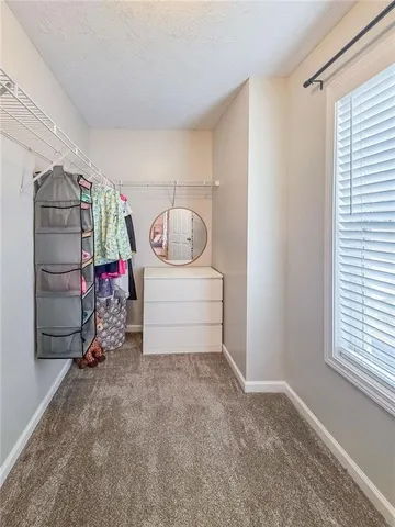 a spacious bathroom with a granite countertop sink a mirror and a shower