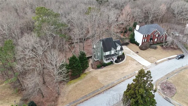 a view of multiple house with large trees