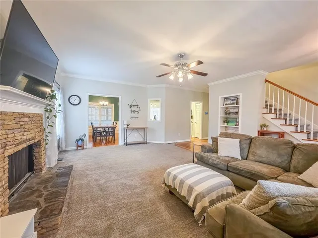 a spacious bedroom with a bed couches and fireplace