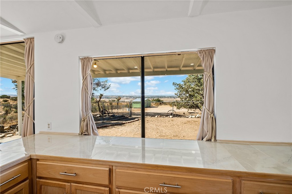 7787 Hidden Ranch Road Apple Valley, CA 92308 - Photo 15 of 36 a kitchen with a window and a glass door