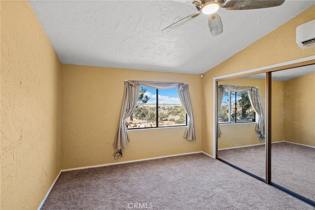 7787 Hidden Ranch Road Apple Valley, CA 92308 - Photo 18 of 36 an empty room with windows and closet