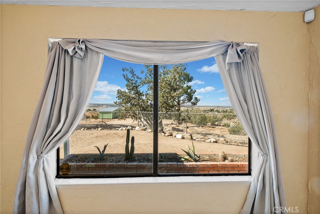 7787 Hidden Ranch Road Apple Valley, CA 92308 - Photo 19 of 36 a view of a glass door and a window