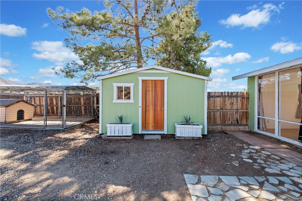 7787 Hidden Ranch Road Apple Valley, CA 92308 - Photo 24 of 36 a view of a house with a backyard