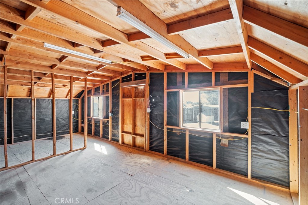 7787 Hidden Ranch Road Apple Valley, CA 92308 - Photo 29 of 36 a view of an empty room with wooden floor and windows