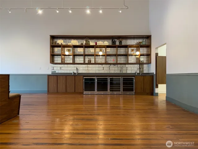 a living room with furniture wooden floor and a chandelier