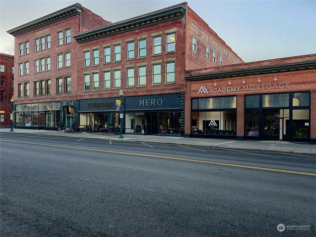 a living room with kitchen island granite countertop wooden floor