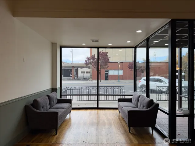 a view of entryway and hall with wooden floor
