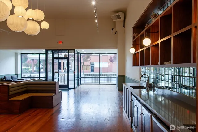 a open kitchen with stainless steel appliances granite countertop a stove and a sink