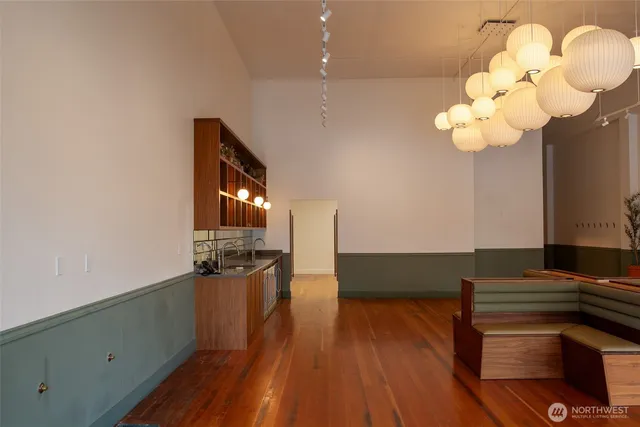 a view of a workspace with furniture and wooden floor