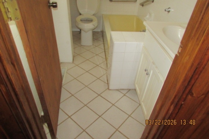 103 1st Street Bradford, IL 61421 - Photo 28 of 48 a bathroom with a granite countertop shower and a toilet