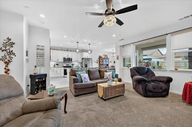 a kitchen with stainless steel appliances granite countertop a sink refrigerator and microwave