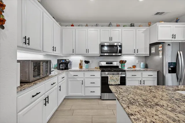 a dining room with furniture a chandelier and wooden floor