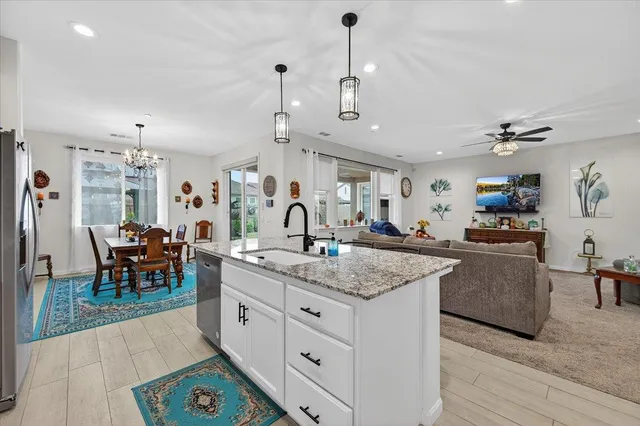 a view of a dining room with furniture a chandelier and wooden floor