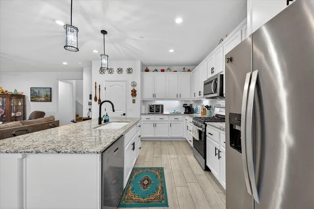 a living room with furniture and kitchen view