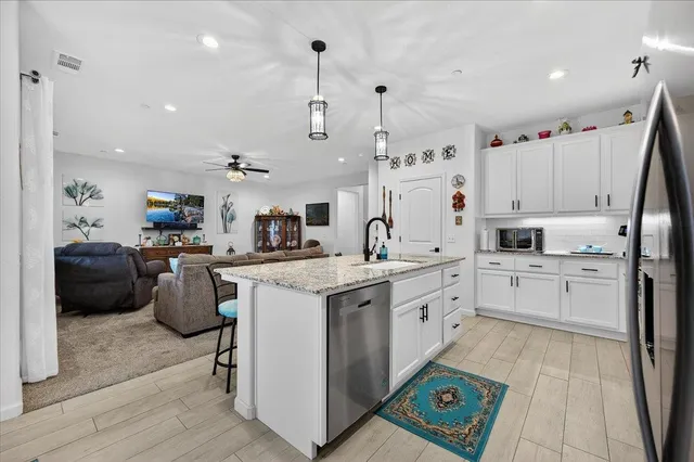 a living room with furniture and a chandelier