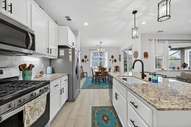 a bedroom with a bed a couch and dresser