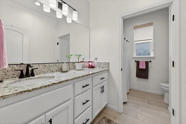 a bathroom with a tub a sink and a mirror