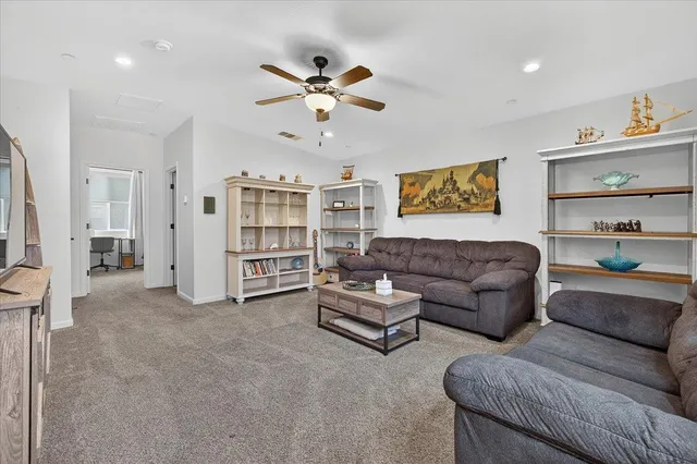 a front view of a house with a garden and plants