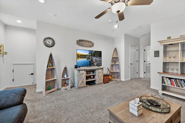 an aerial view of a house with a swimming pool and lake view