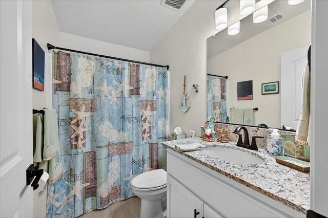 an aerial view of a house with a garden and lake view