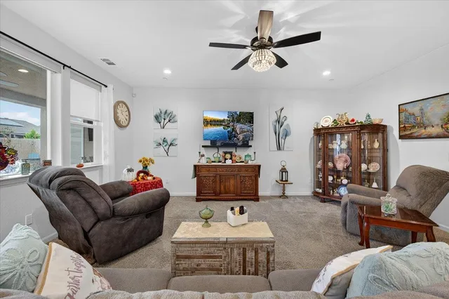 a living room with furniture and a view of kitchen