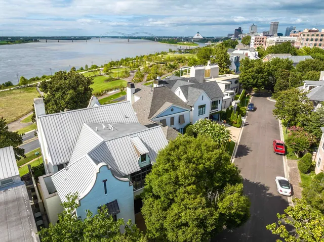 an aerial view of house with yard and ocean view