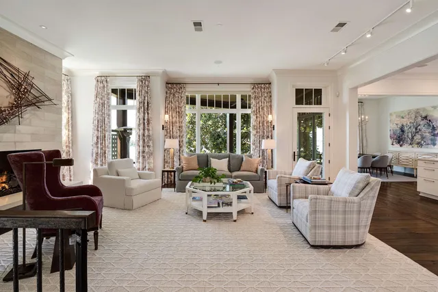 a living room with furniture and large windows