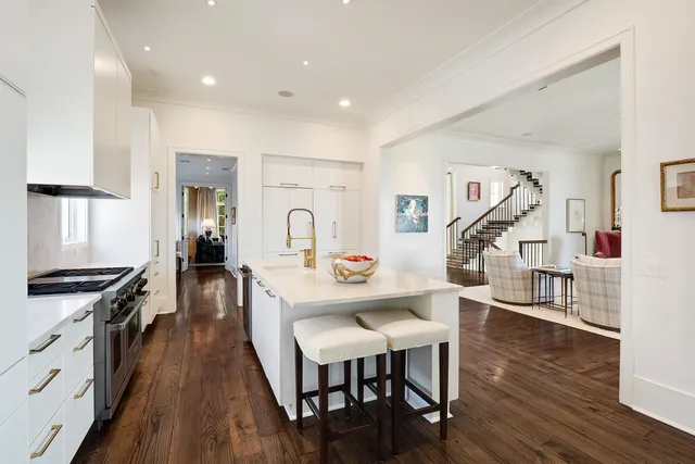 a view of a kitchen with cabinets and wooden floor