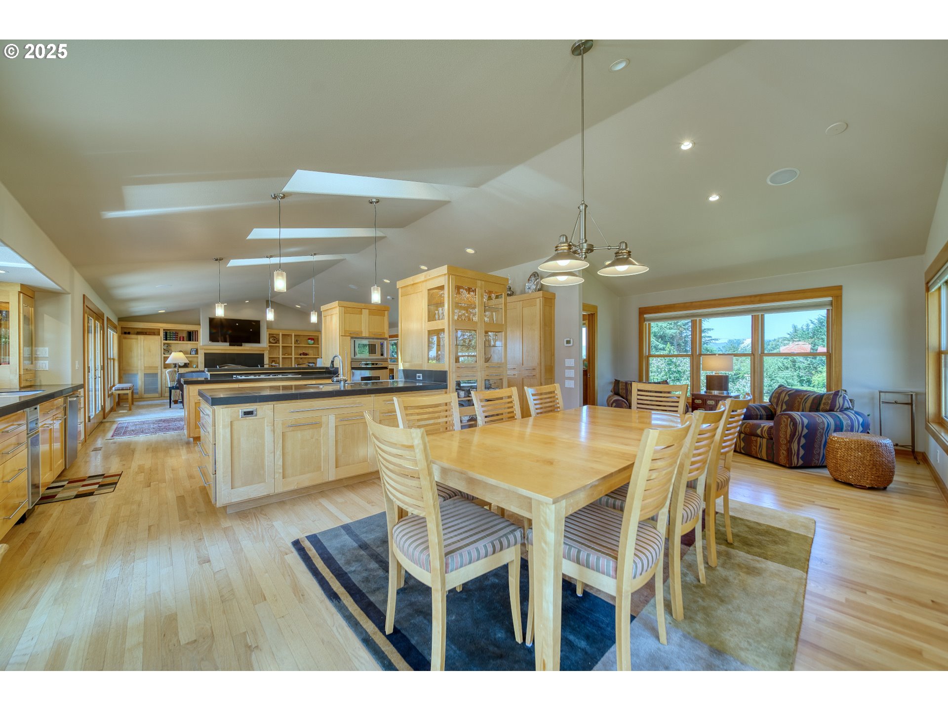 22732 Northwest Gillihan Road Portland, OR 97231 - Photo 20 of 48 a view of a dining room with furniture wooden floor and chandelier