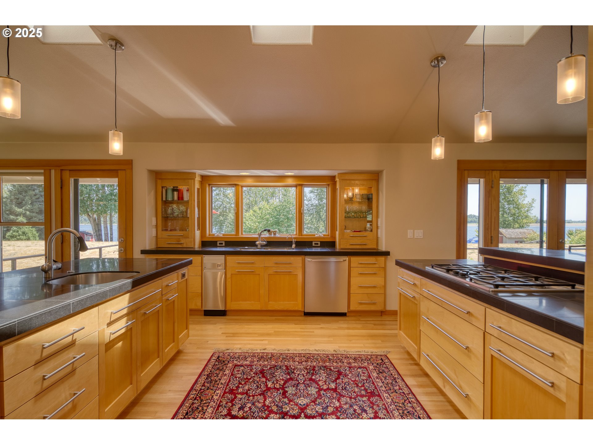 22732 Northwest Gillihan Road Portland, OR 97231 - Photo 21 of 48 a large kitchen with stainless steel appliances granite countertop a stove a sink and a refrigerator