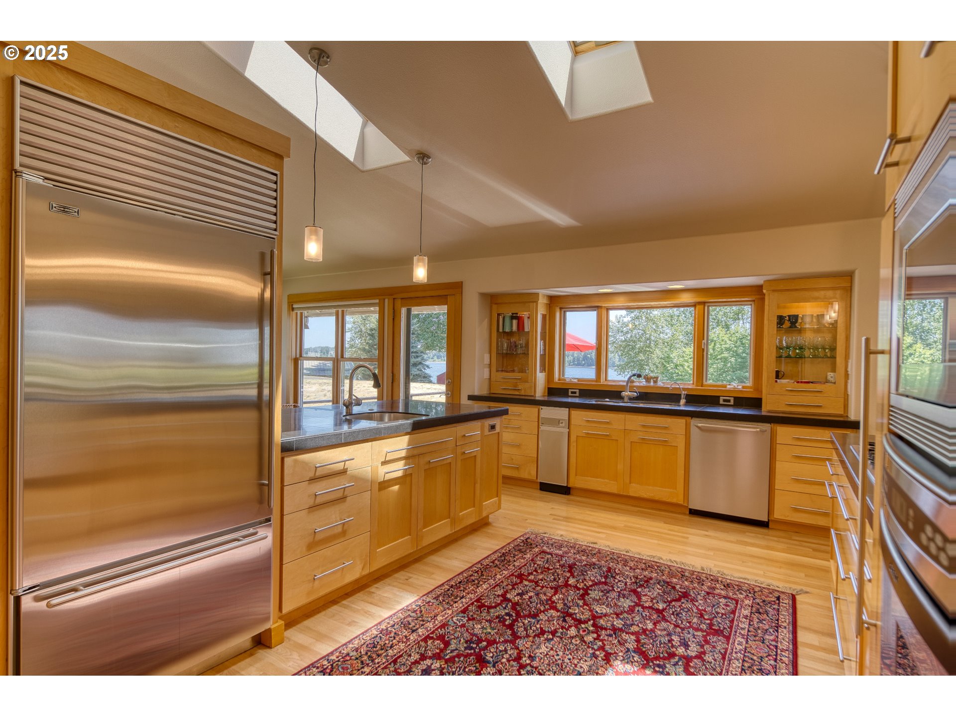 22732 Northwest Gillihan Road Portland, OR 97231 - Photo 22 of 48 a large white kitchen with a large window