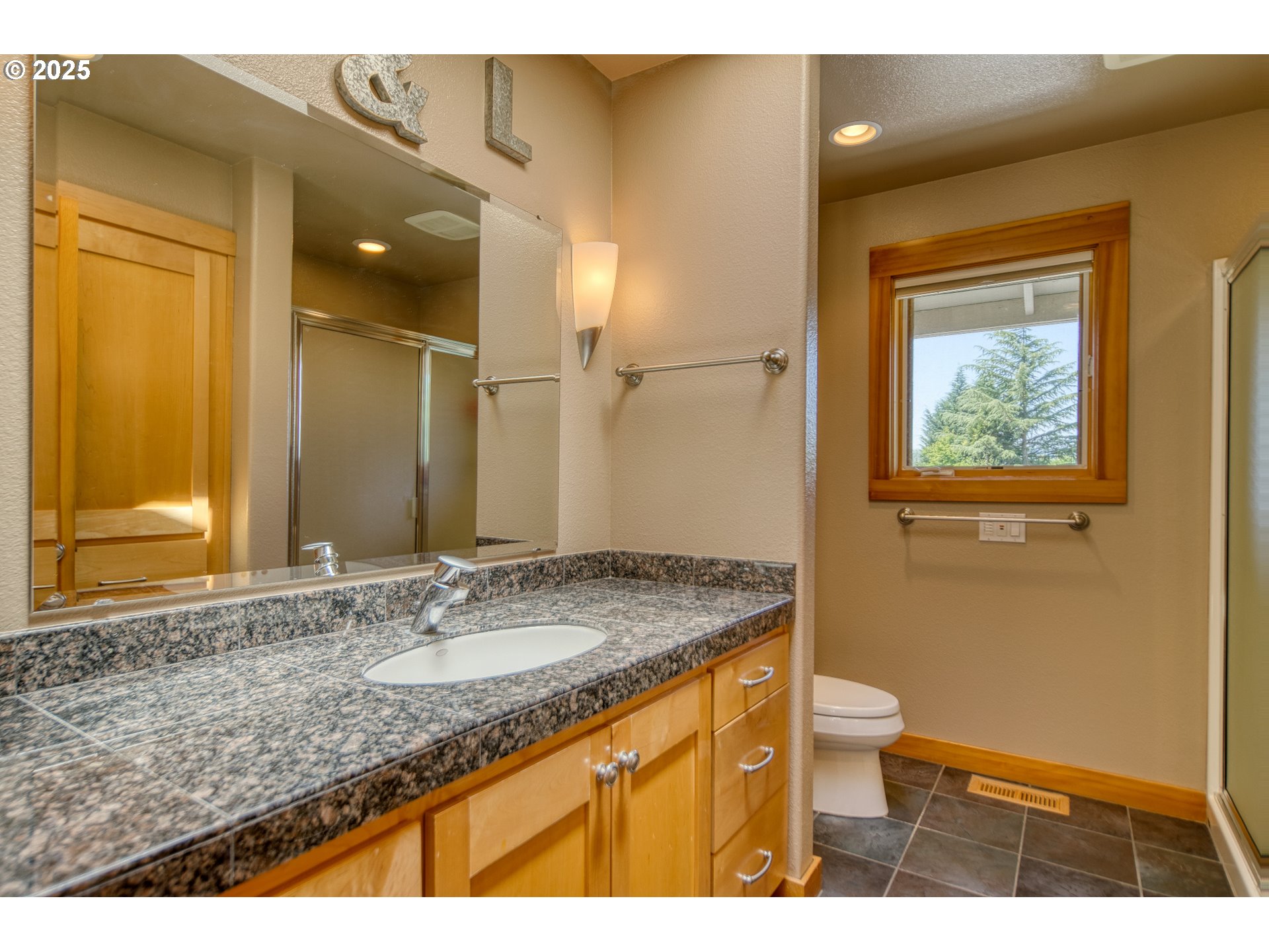 22732 Northwest Gillihan Road Portland, OR 97231 - Photo 26 of 48 a bathroom with a granite countertop sink toilet and shower