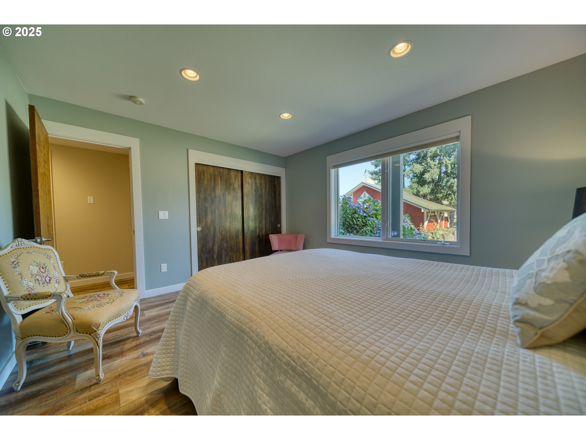 22732 Northwest Gillihan Road Portland, OR 97231 - Photo 5 of 48 a bedroom with a bed and a window