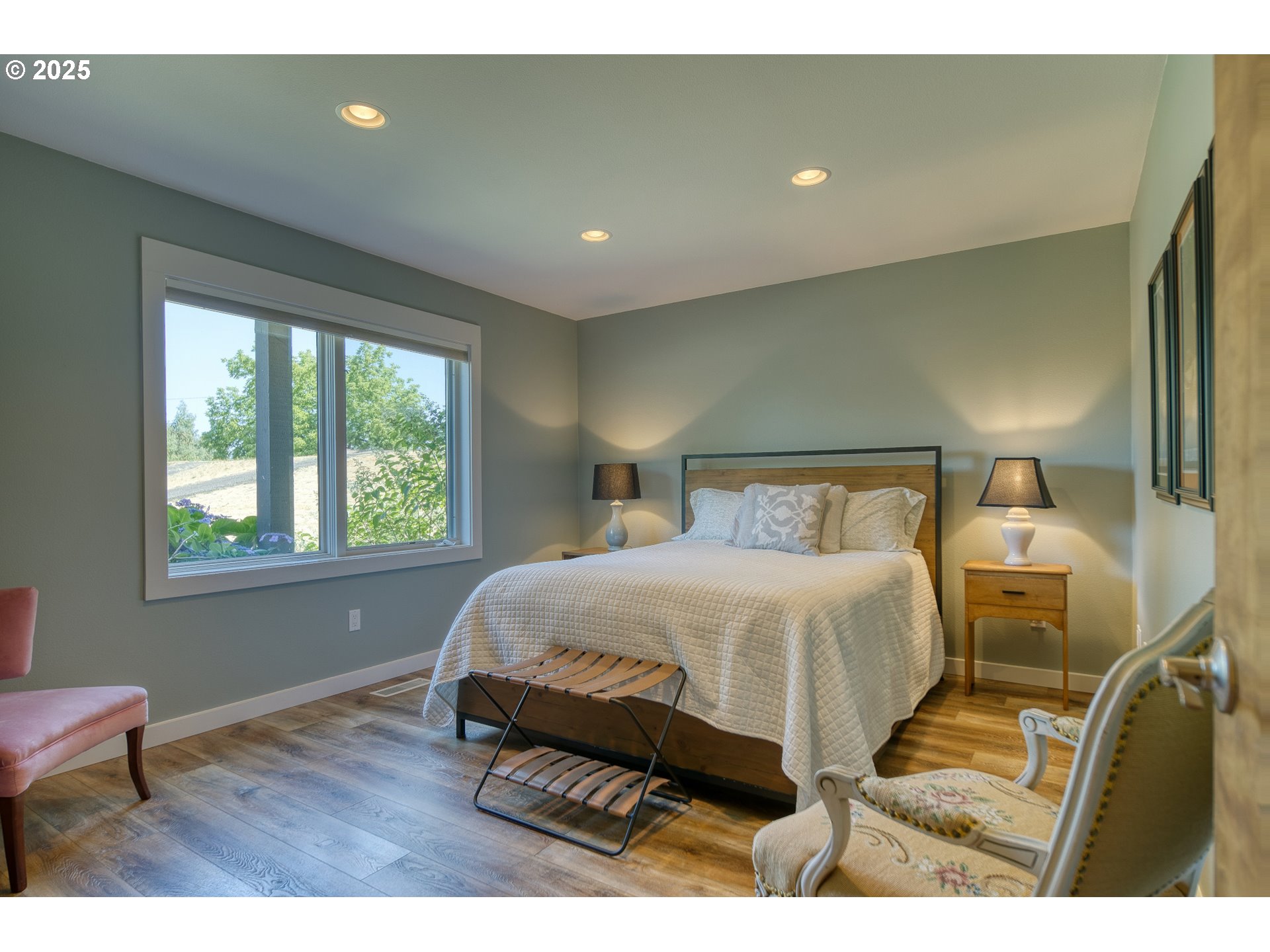 22732 Northwest Gillihan Road Portland, OR 97231 - Photo 6 of 48 a bedroom with a bed and wooden floor