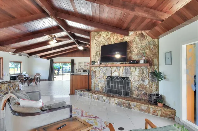 a living room with furniture and a floor to ceiling window