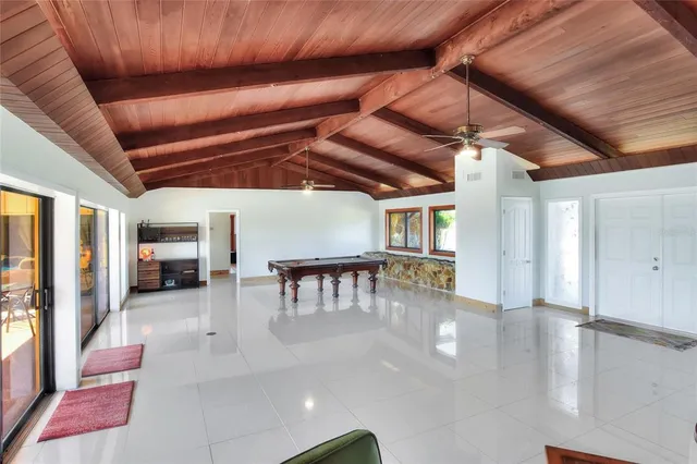 an aerial view of residential houses with outdoor space and ocean view