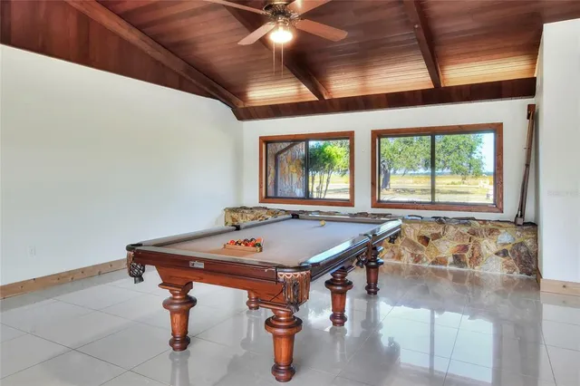 a view of a house with swimming pool and sitting area