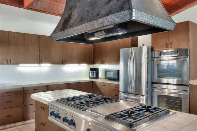 a room with gym equipment and a view of living room