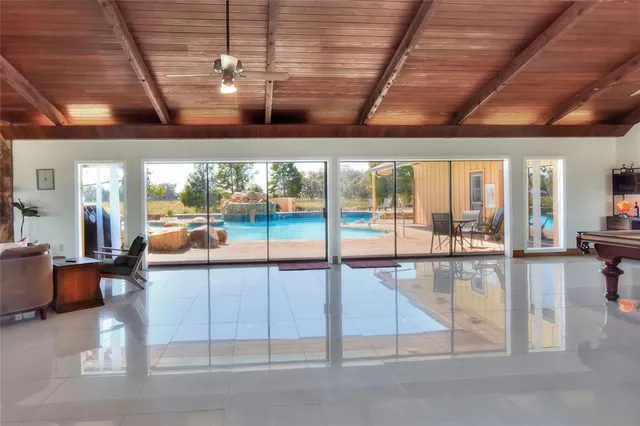 a kitchen with stainless steel appliances granite countertop a table chairs stove and cabinets