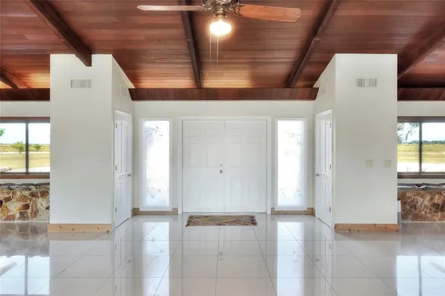 a spacious bathroom with a granite countertop sink a mirror and a shower