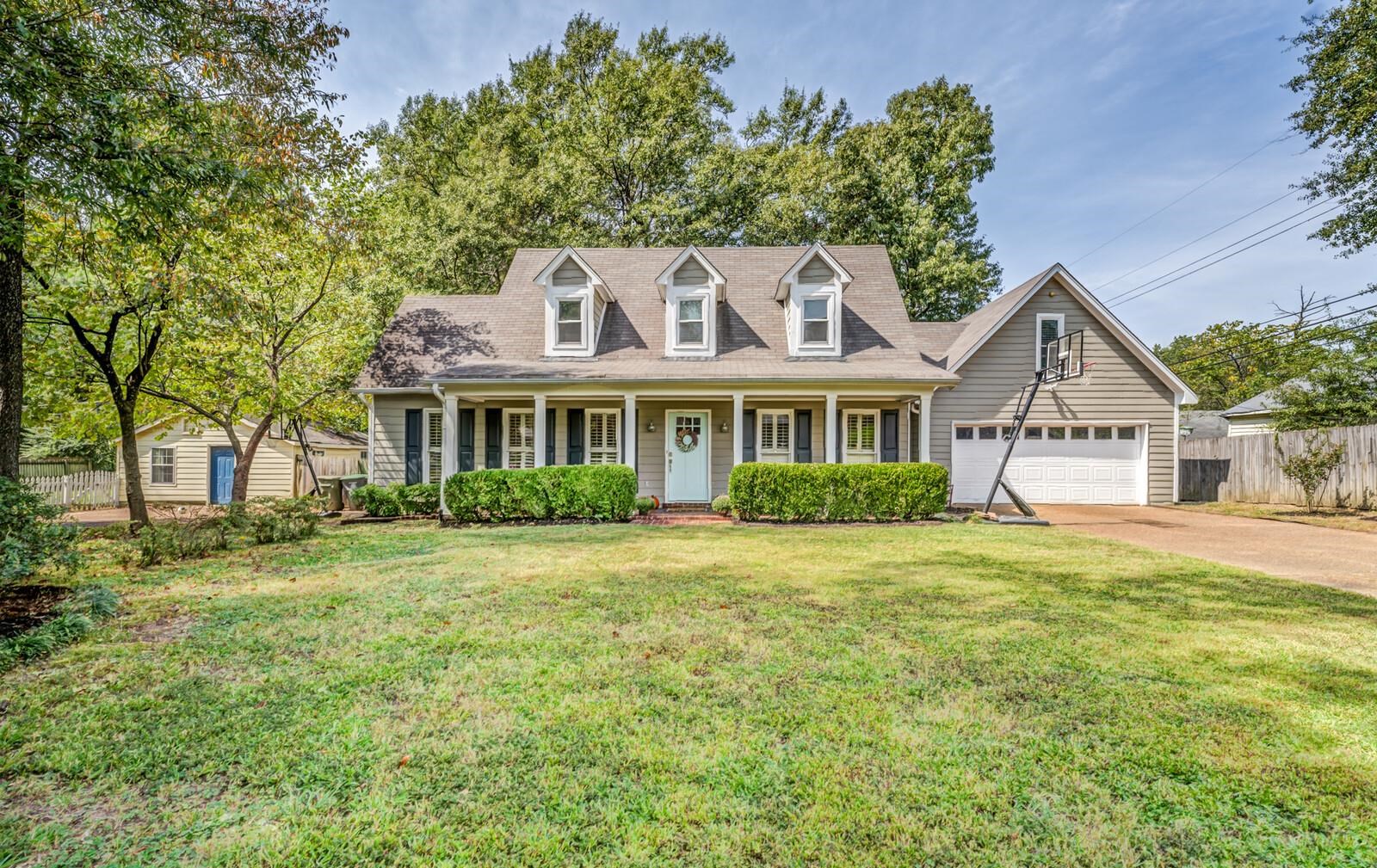 a front view of a house with a garden